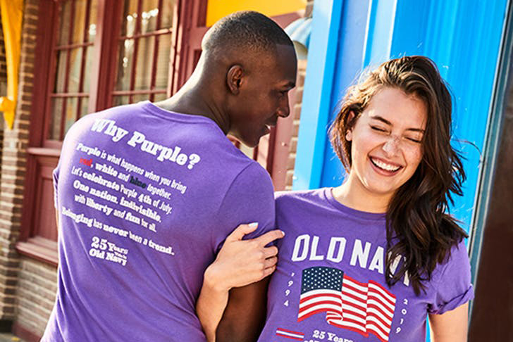 Two models wearing purple flag tees in honor of Old Navy's 25th Anniversary